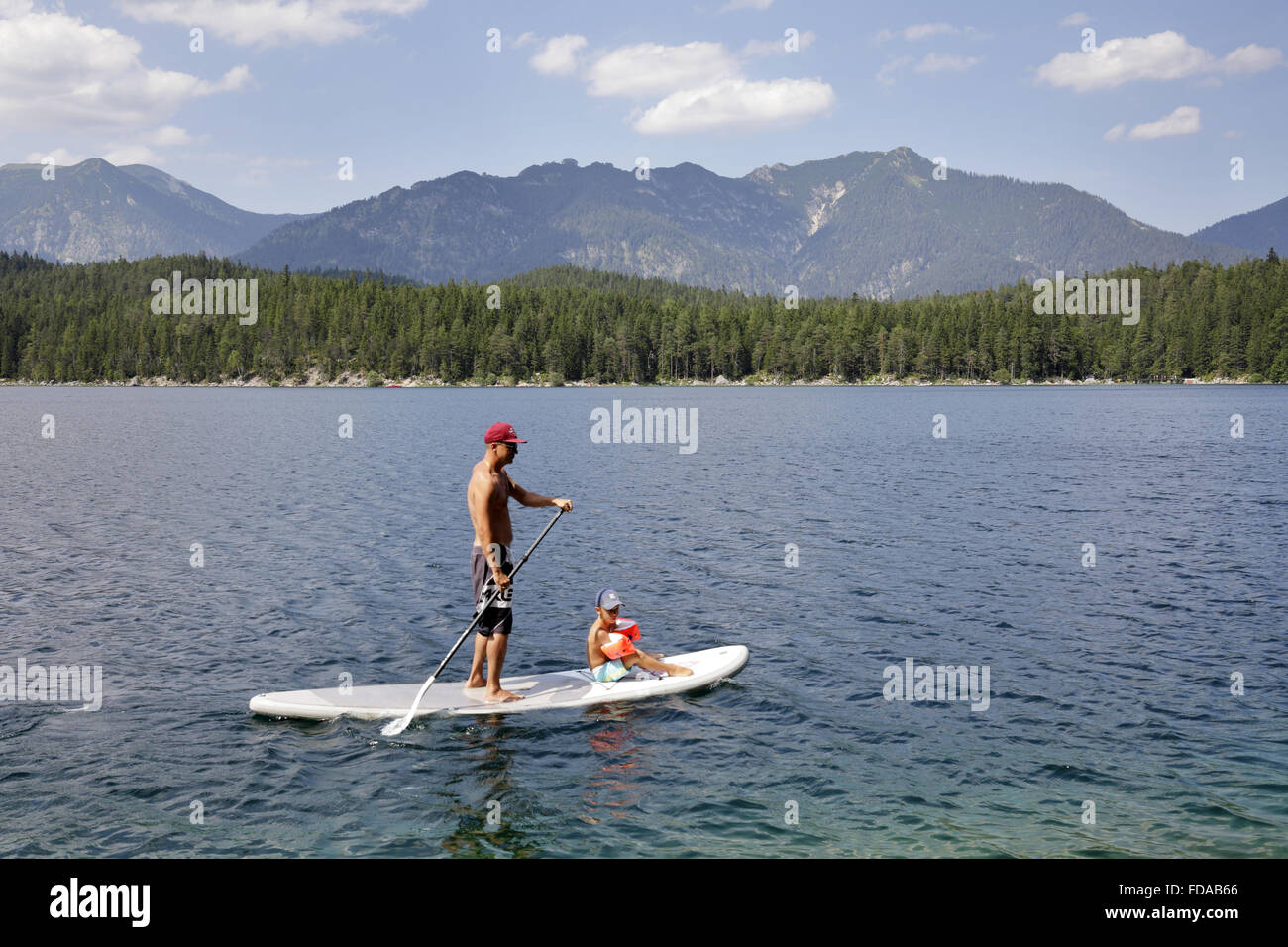 Eibsee, Germany, man with child at the standup paddling on Eibsee