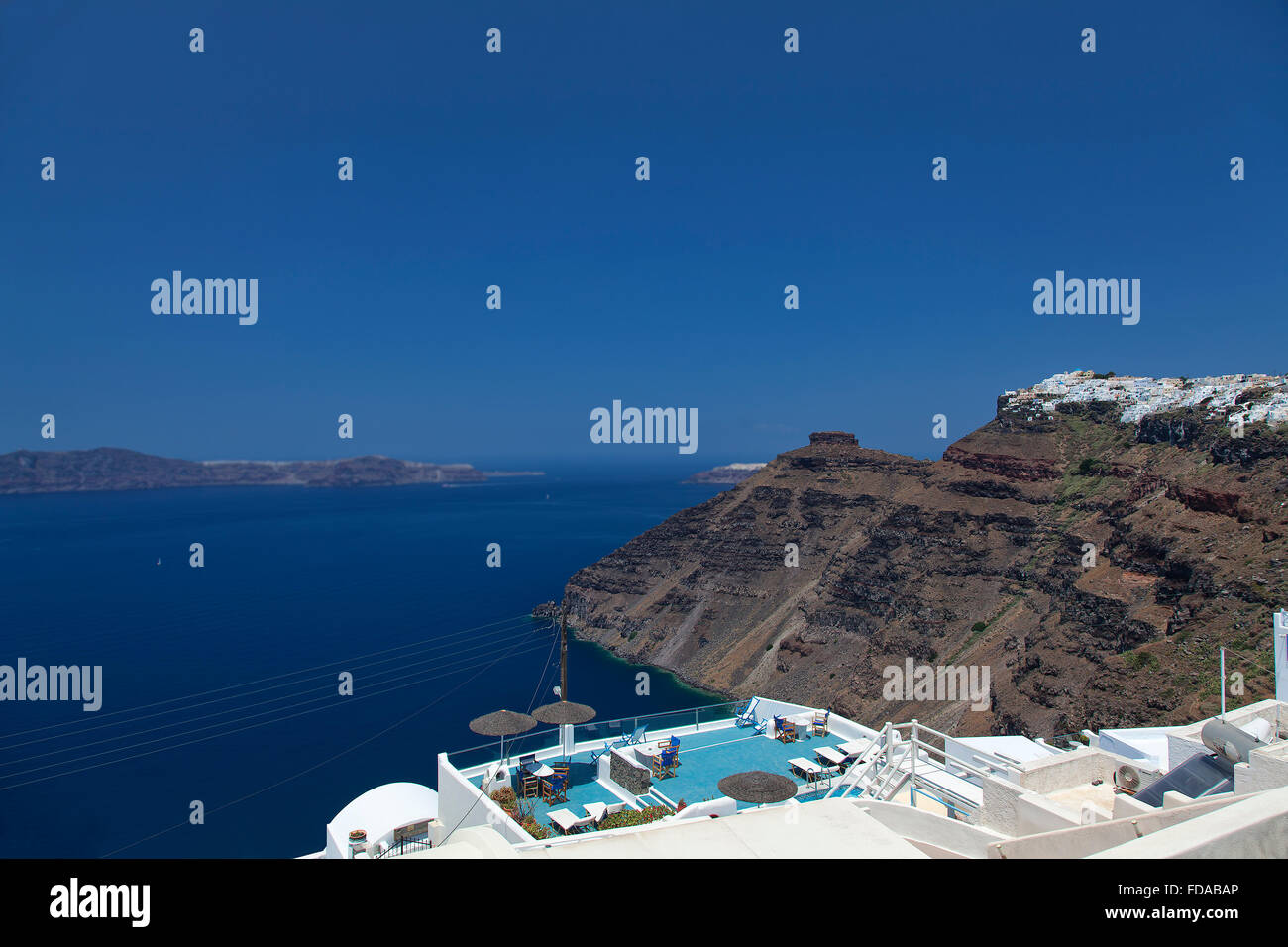 A panoramic image from Santorini of the villages of imerovigli and Oia with the rock of skaros in between them. Stock Photo