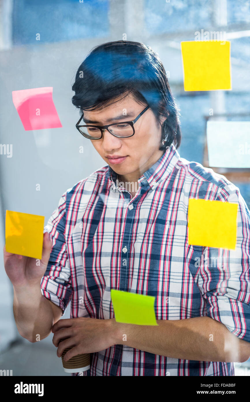 Creative businessman writing on sticky notes Stock Photo - Alamy