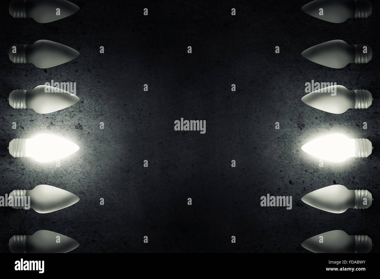 Light bulbs on dark background with one glowing Stock Photo - Alamy