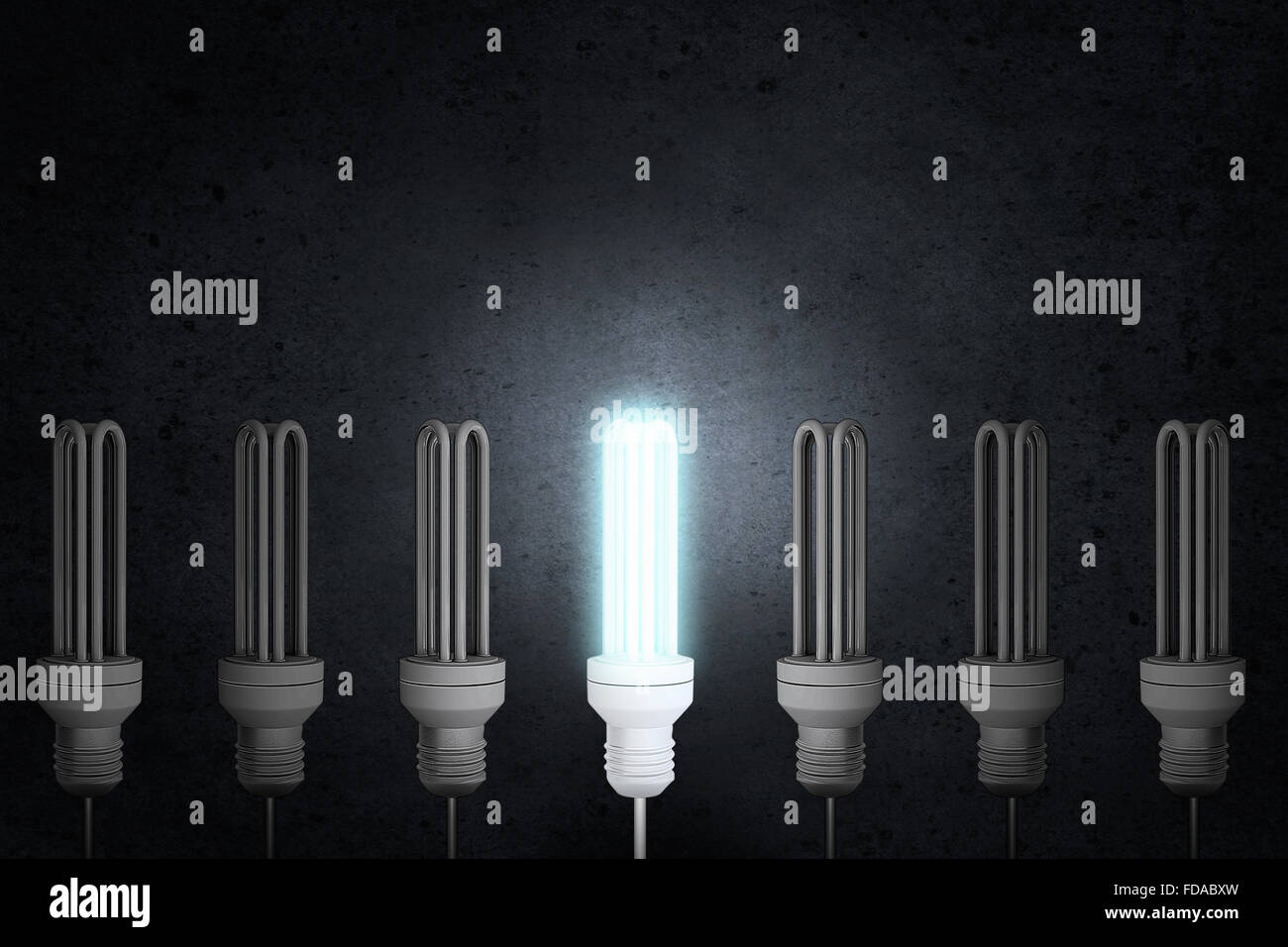 Light bulbs on dark background with one glowing Stock Photo - Alamy