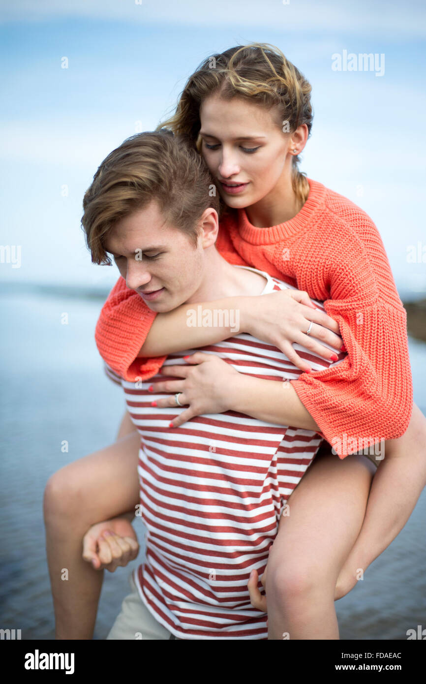 Beautiful young couple at the beach. They look very content and happy together. Stock Photo