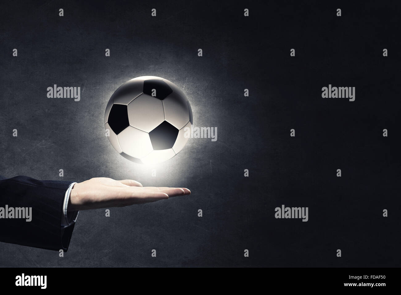 Close up of elegant businessman holding soccer ball in hand Stock Photo ...