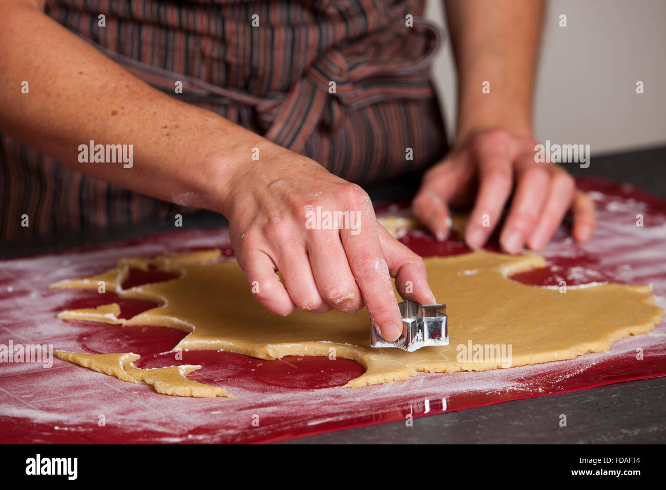 Woman cutting cookie shapes out of dough Stock Photo