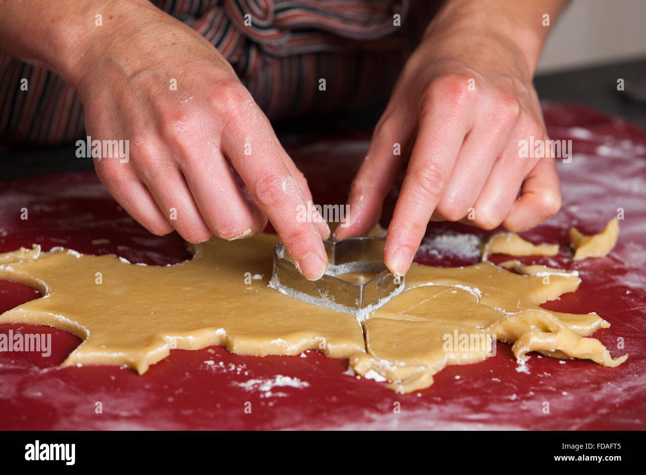 Woman cutting cookie shapes out of dough Stock Photo