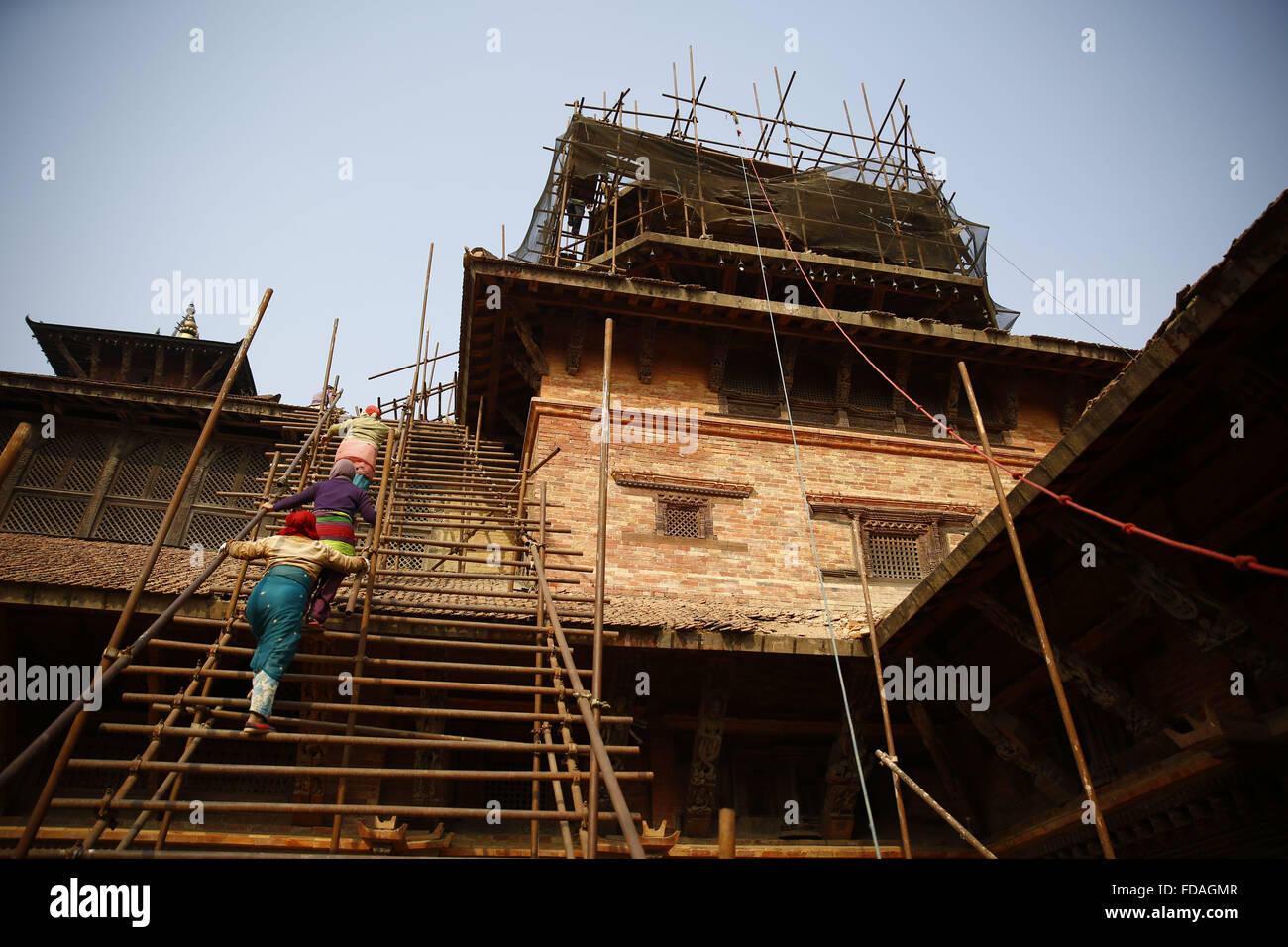 Jan. 29, 2016 - Lalitpur, Nepal - Woman laborers ascend staircases as the rebuilding of Taleju Temple is under reconstruction after the damages triggered by the April 25, 2015 earthquake in Mul Chowk, Patan, Lalitpur on Friday, January 29, 16. The temple of Taleju was built in honor of the female royal deity, Taleju Bhawani. It was constructed in 1667 during the reign of King Shree Niwas Malla. (Credit Image: © Skanda Gautam via ZUMA Wire) Stock Photo