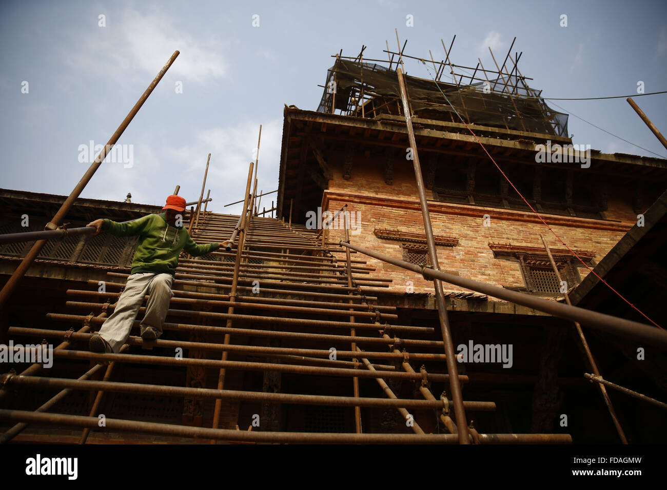 Jan. 29, 2016 - Lalitpur, Nepal - A man laborer decends staircases as the rebuilding of Taleju Temple is under reconstruction after the damages triggered by the April 25, 2015 earthquake in Mul Chowk, Patan, Lalitpur on Friday, January 29, 16. The temple of Taleju was built in honor of the female royal deity, Taleju Bhawani. It was constructed in 1667 during the reign of King Shree Niwas Malla. (Credit Image: © Skanda Gautam via ZUMA Wire) Stock Photo