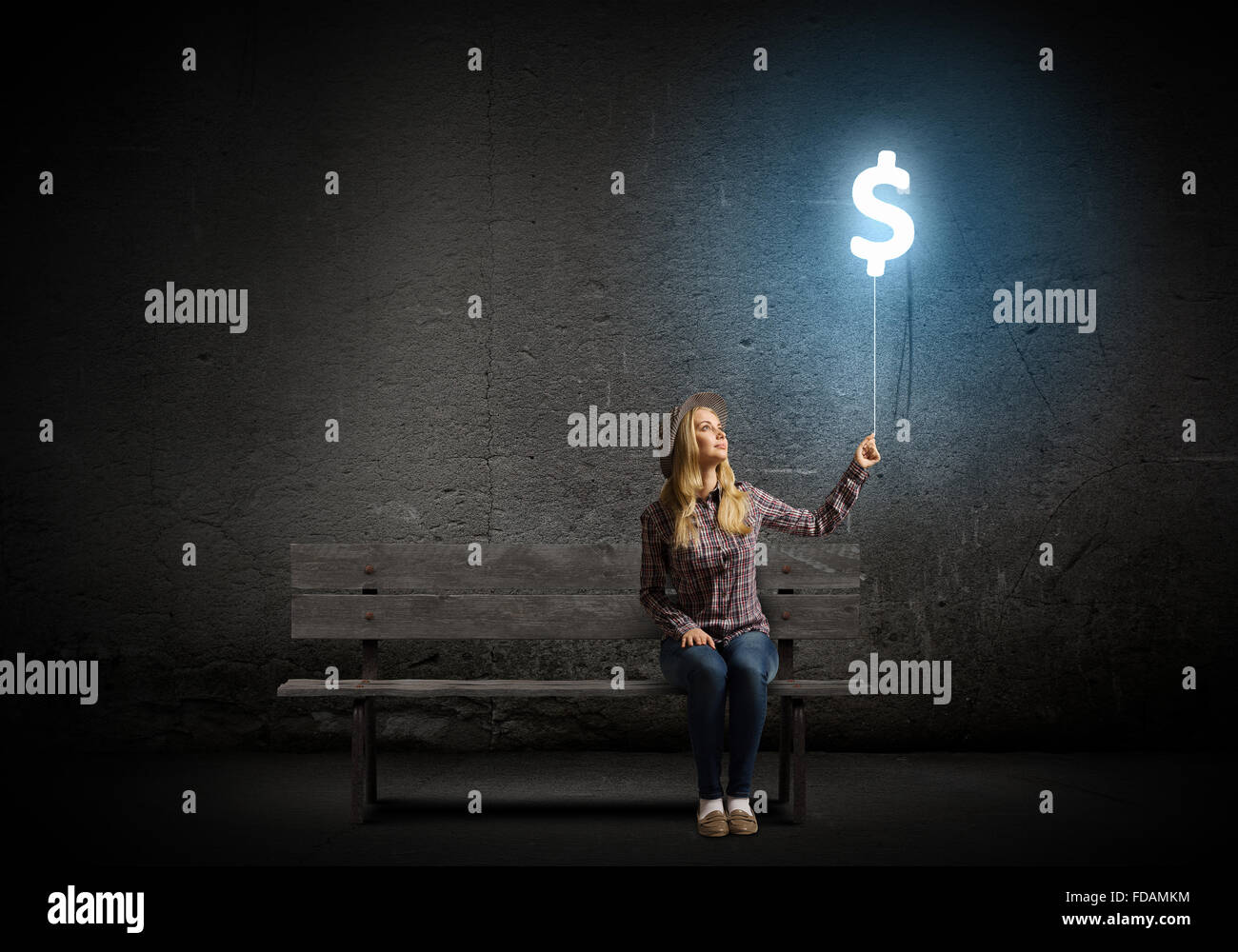 Young woman holding balloon shaped like dollar sign Stock Photo - Alamy