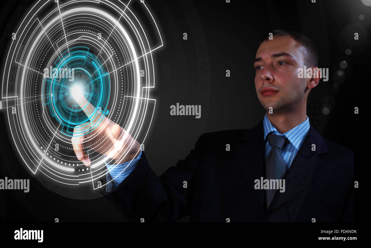 Young businessman pressing high tech circle icon on media screen Stock Photo