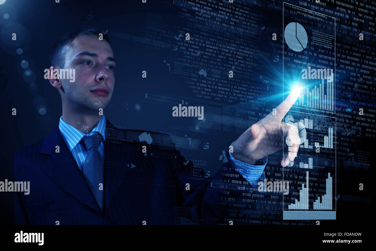 Young businessman pressing high tech icon on media screen Stock Photo