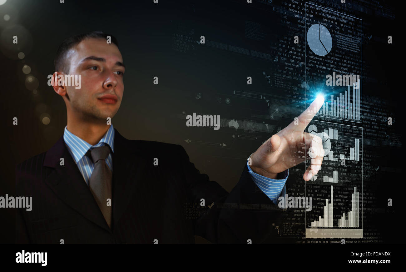 Young businessman pressing high tech icon on media screen Stock Photo