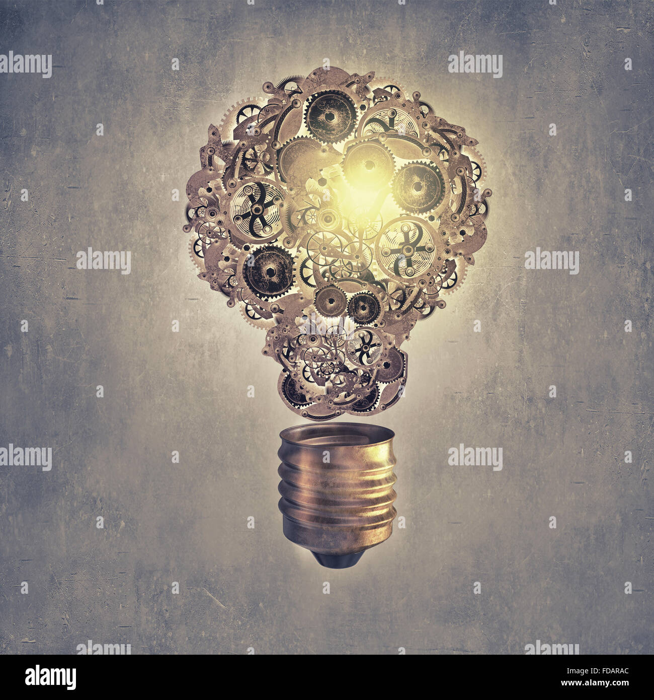 Light bulb concept with gears inside on cement background Stock Photo