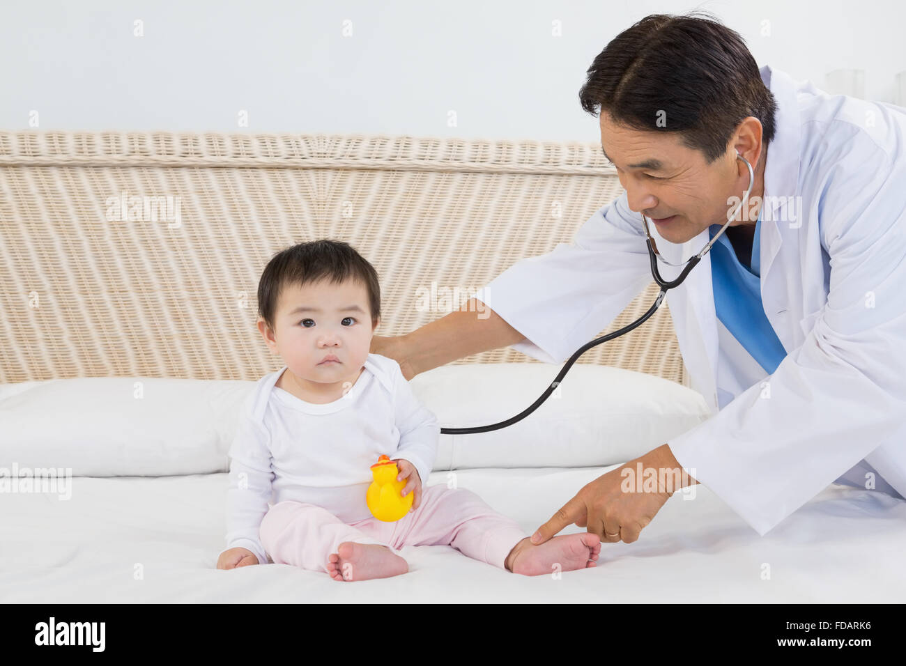 Doctor visiting cute baby Stock Photo