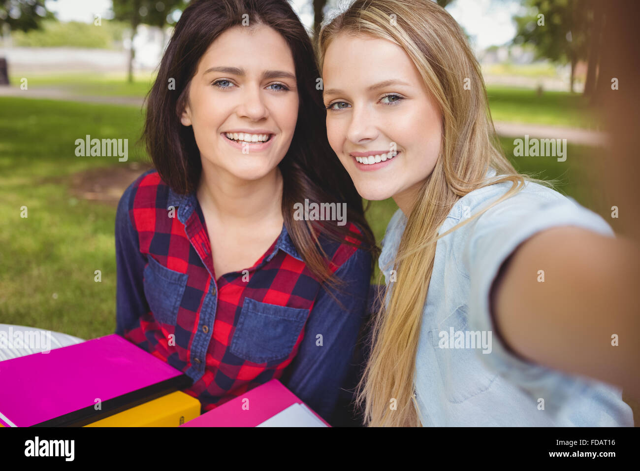 Smiling students studying outdoor Stock Photo - Alamy