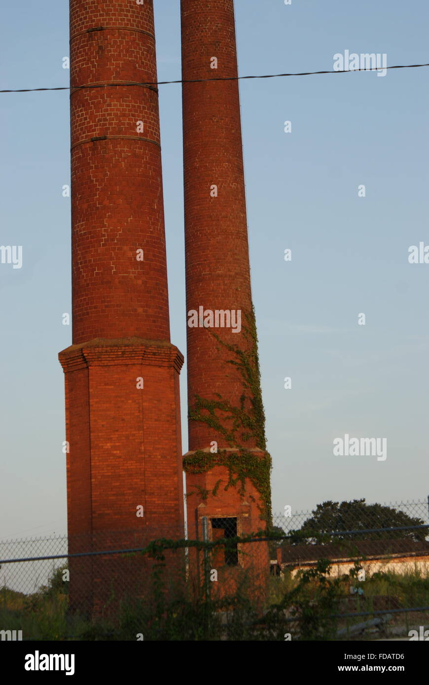 Two old abandoned factory smoke stacks in Georgia. Stock Photo
