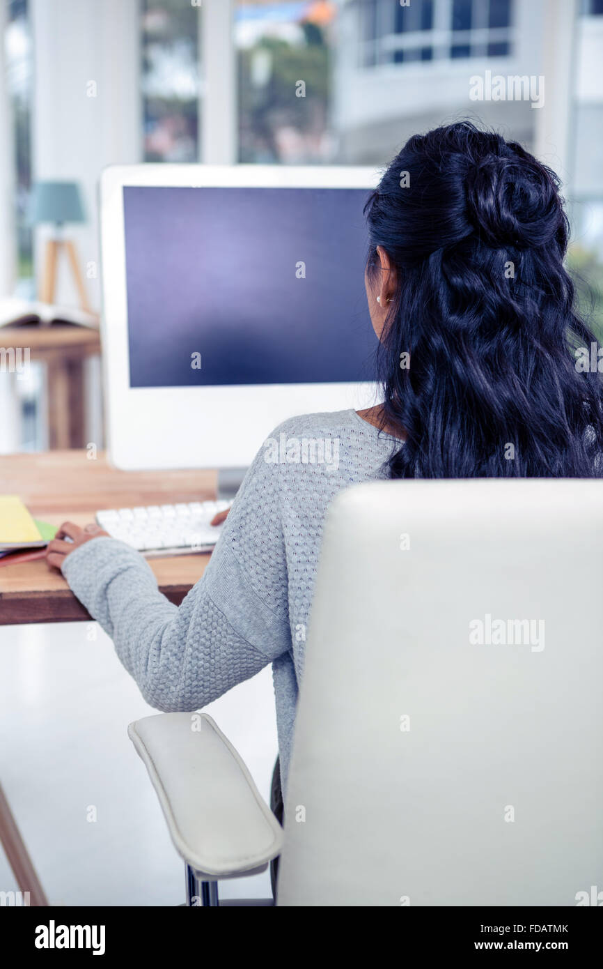 Rear view of woman using computer Stock Photo - Alamy