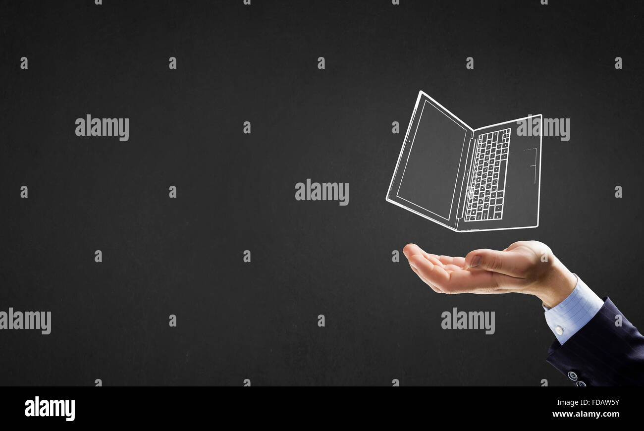 Human hand holding in palm laptop symbol Stock Photo - Alamy