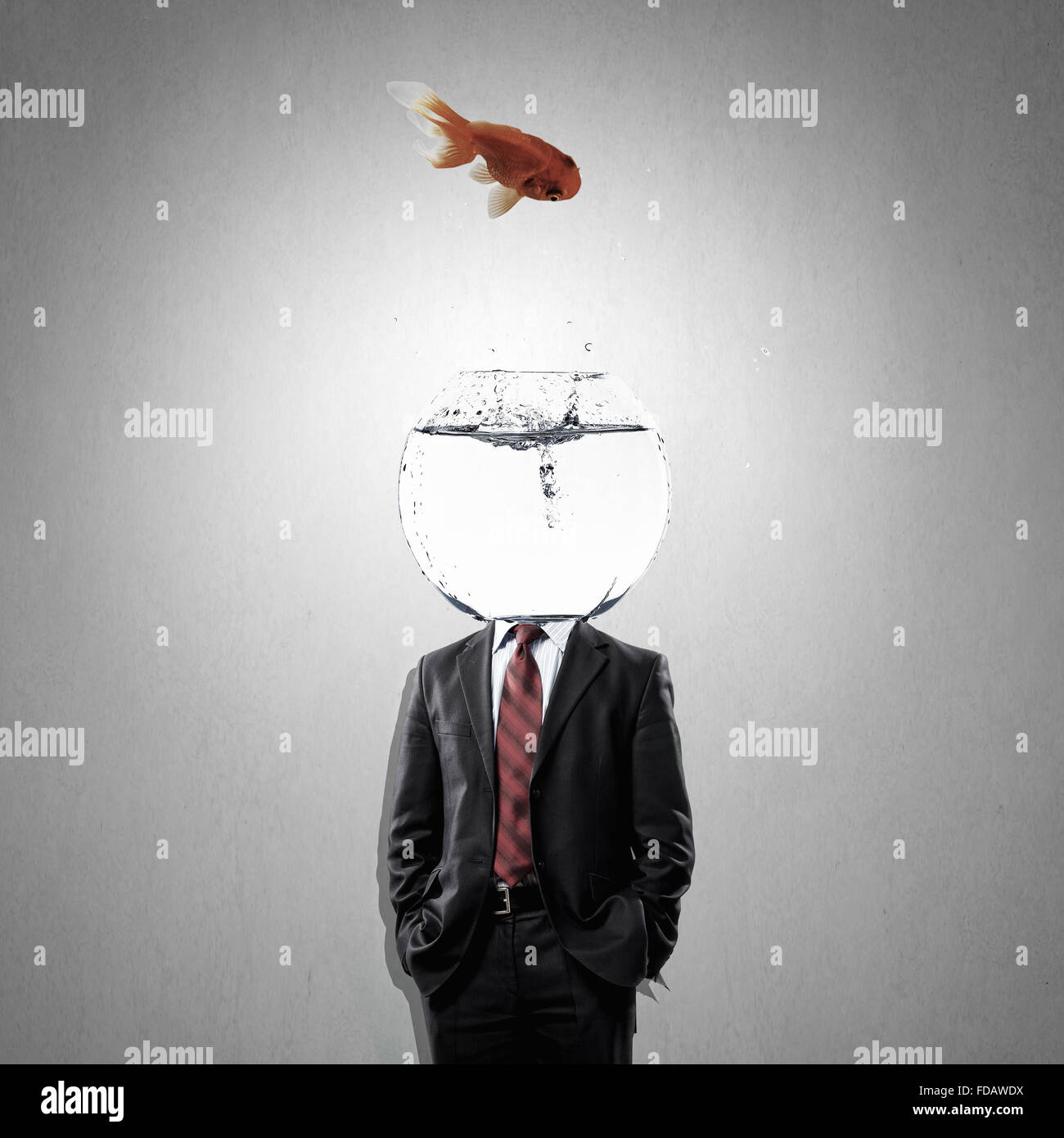 Man with water bowl with fish instead of head Stock Photo Alamy