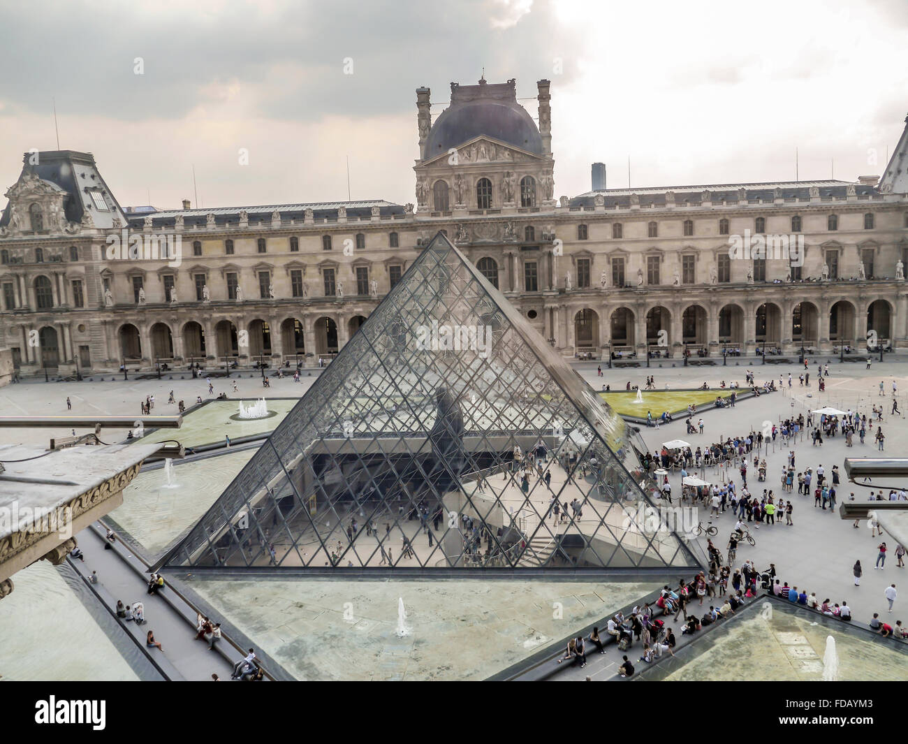 PARIS, FRANCE - AUGUST 28 2013: - The main courtyard of the Louvre Museum with the glass Pyramid Stock Photo