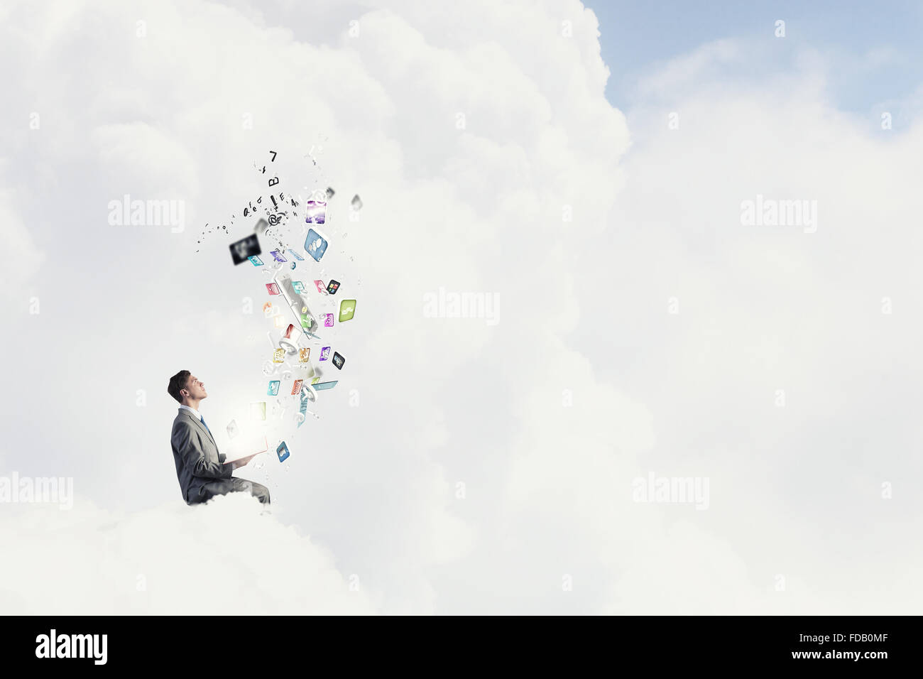 Young businessman sitting on cloud with book and icons flying in air ...