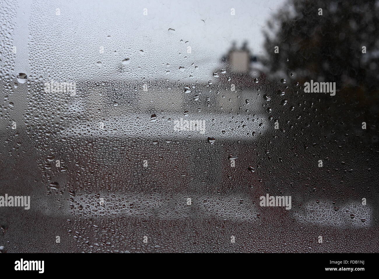 View on the house through the glass pane covered by condensate, January 25, 2016 Stock Photo