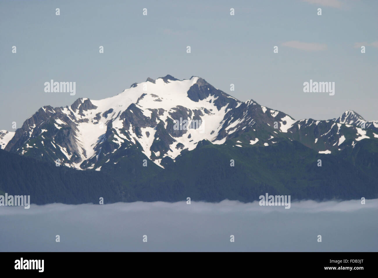 Beautiful scenery with mountains rising above the clouds, in Yakutat, Alaska Stock Photo