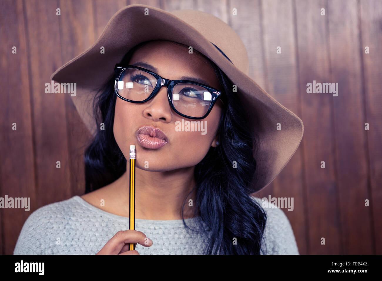 Asian woman holding pencil Stock Photo - Alamy