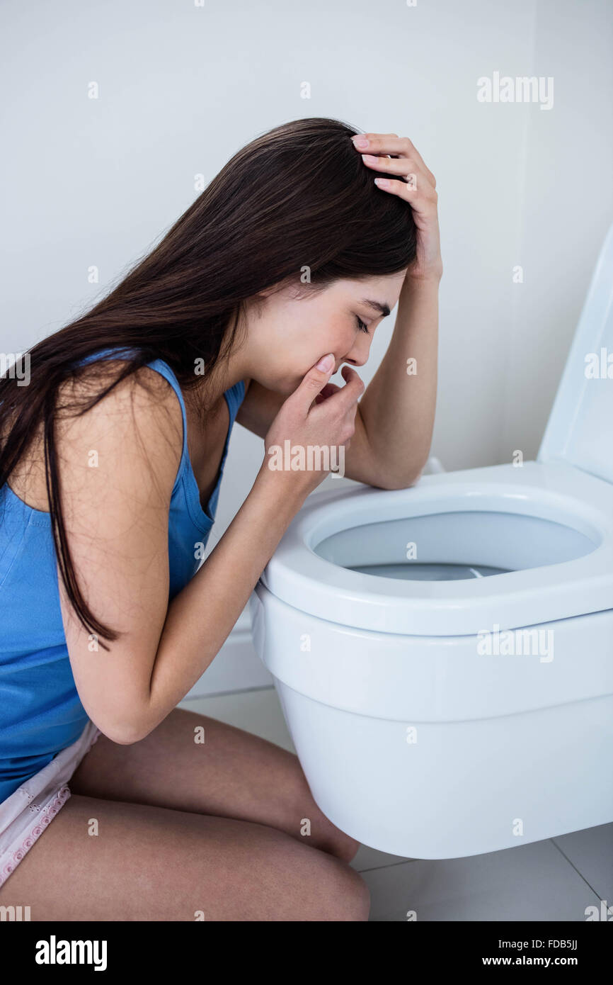 Rear view of woman throwing up Stock Photo Alamy