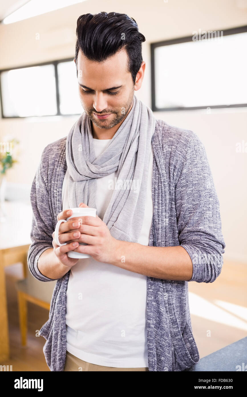 Handsome man drinking hot beverage Stock Photo - Alamy
