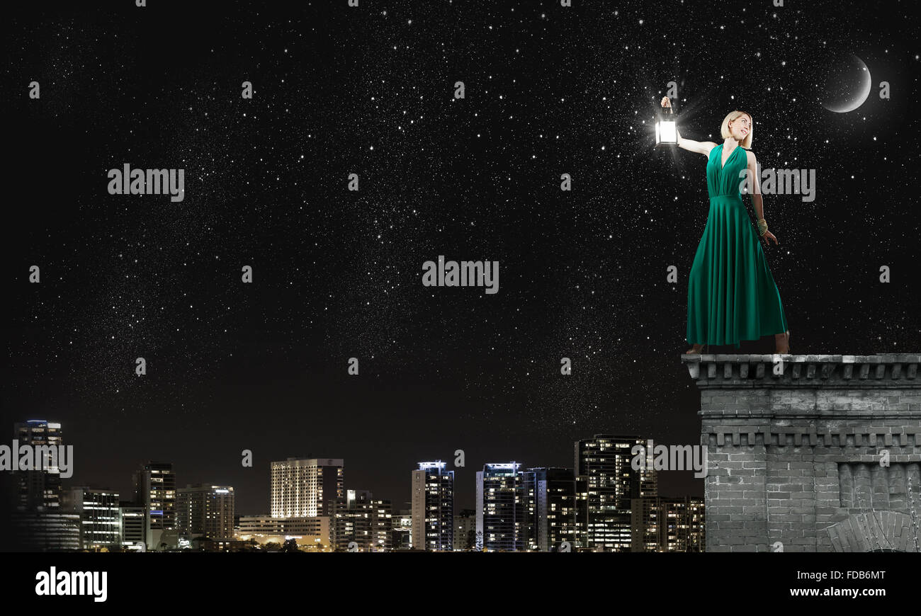 Young woman in green dress with lantern at night Stock Photo - Alamy