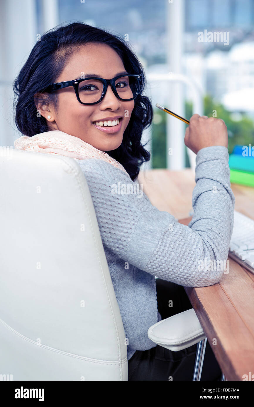 Asian businesswoman holding pencil Stock Photo - Alamy