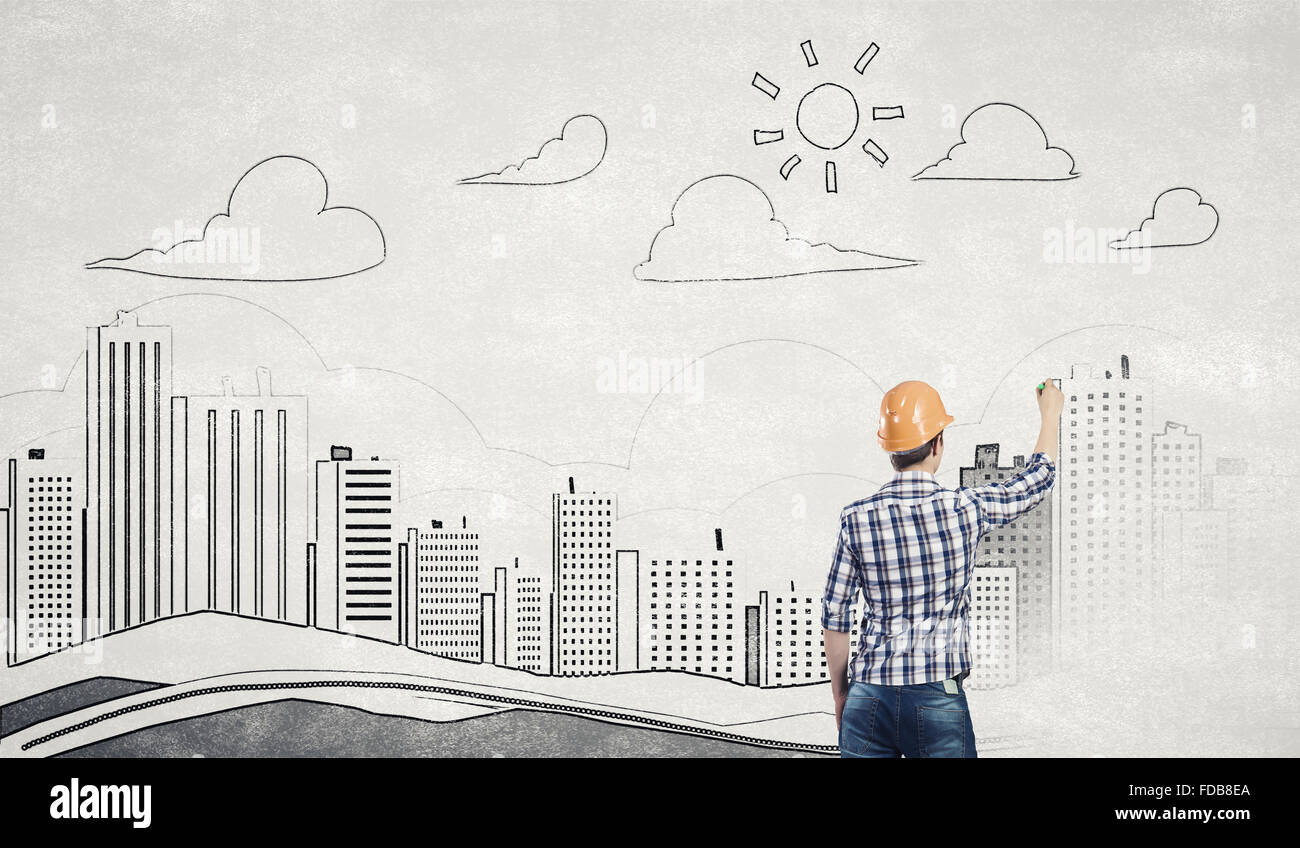 Rear view of engineer drawing project of business district Stock Photo ...