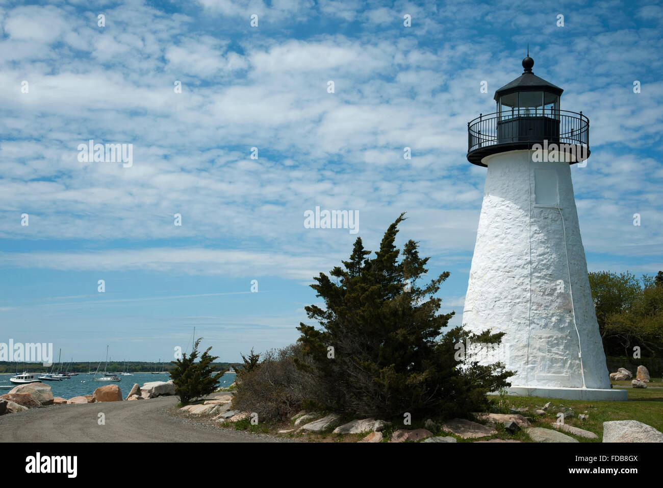 Ned’s Point lighthouse overlooks Mattapoisett Harbor in Massachusetts, on a warm springtime day. It is situated inside Veterans Memorial Park. Stock Photo