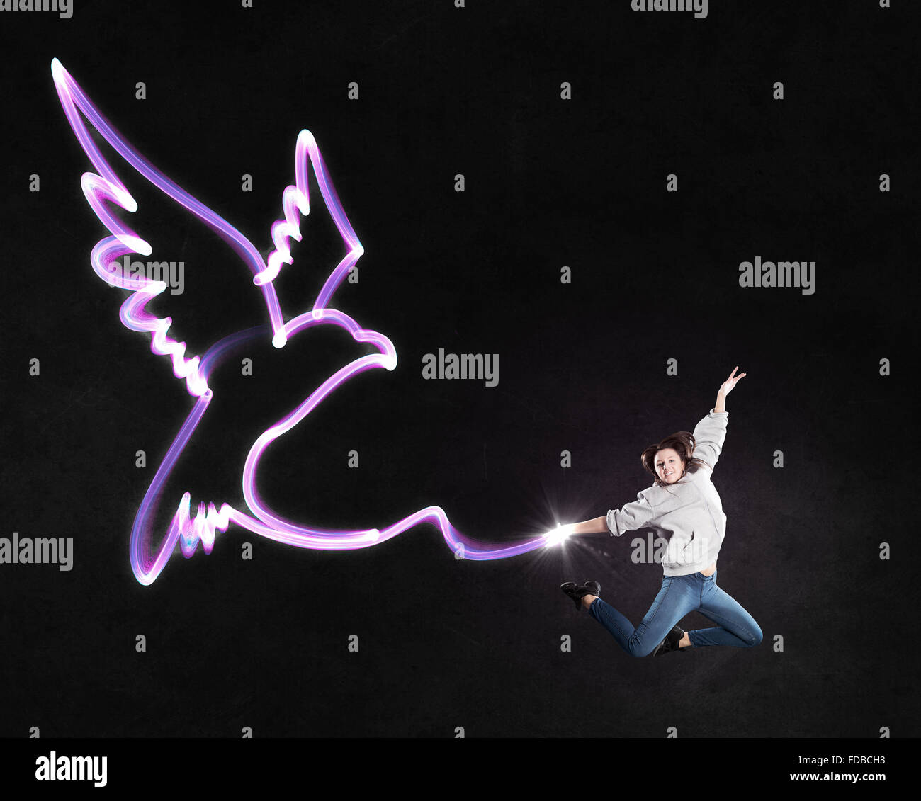 Young girl with drawn wings jumping high in sky Stock Photo - Alamy