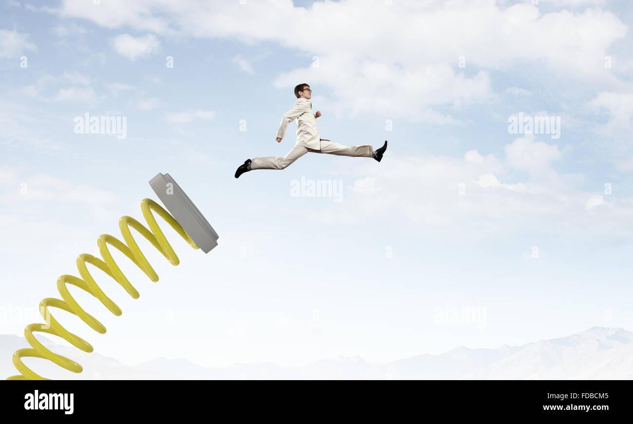 Businessman jumping on springboard as progress concept Stock Photo - Alamy