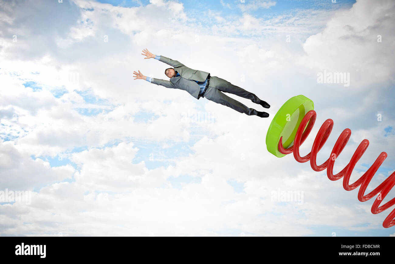Businessman jumping on springboard as progress concept Stock Photo - Alamy
