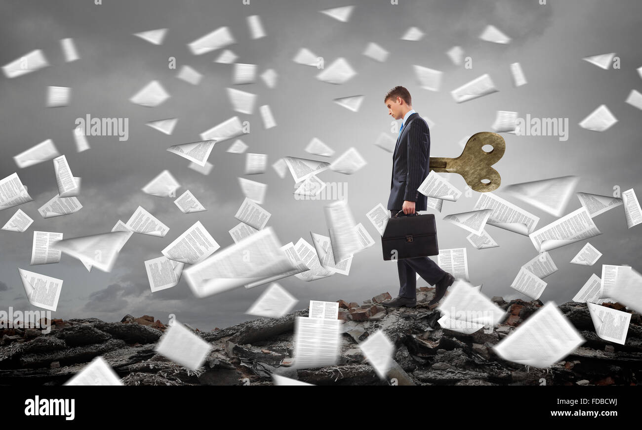 Young businessman walking with wind up key in his back Stock Photo Alamy
