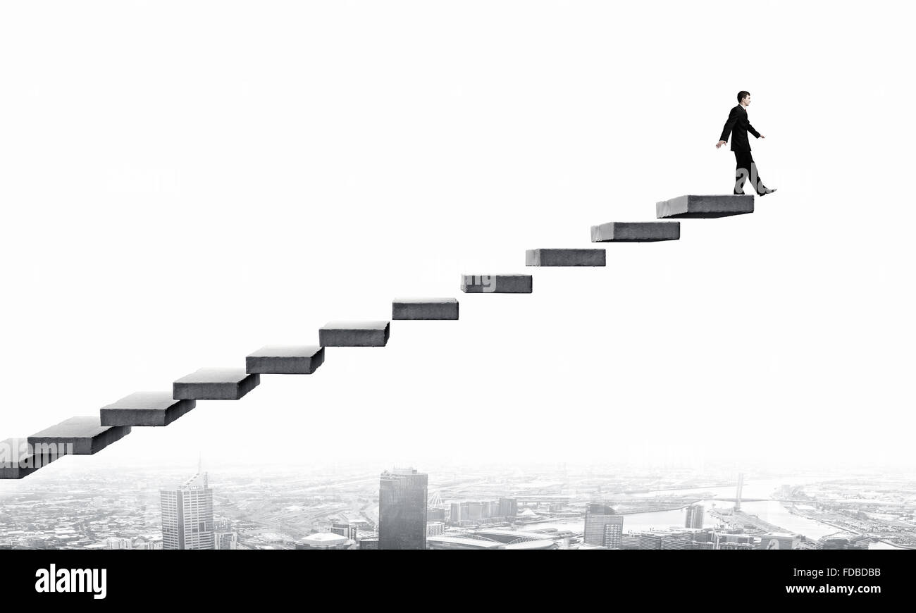 Young businessman walking up on staircase representing success concept ...