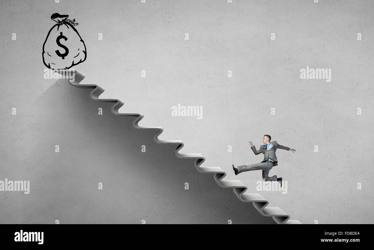 Young businessman running up on staircase representing success concept ...