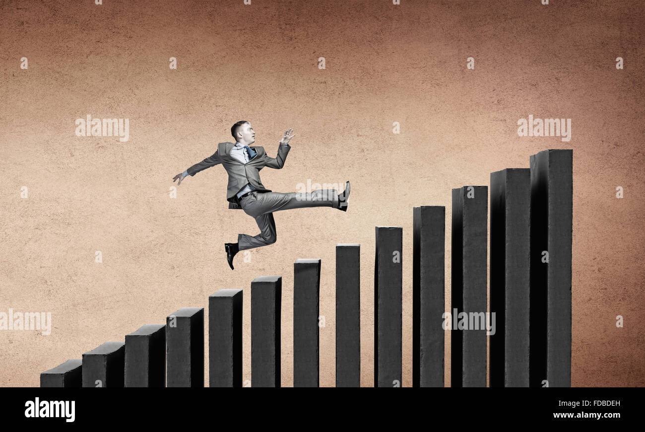 Young businessman running up on staircase representing success concept ...