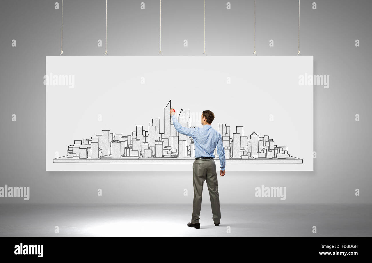Rear View Of Builder Man Drawing Construction Project On White