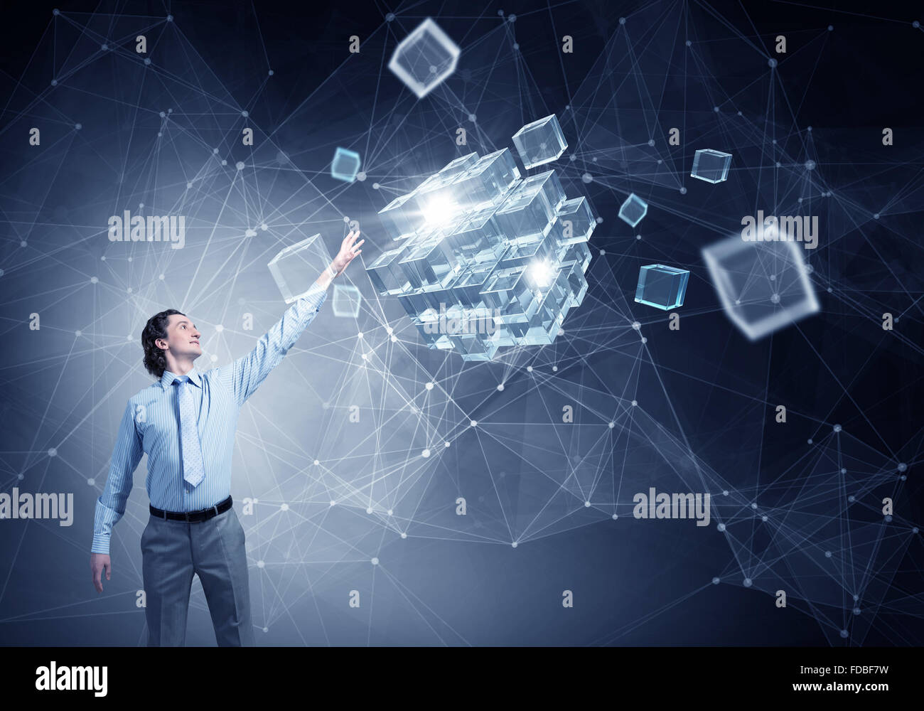 Businessman reaching hand to touch digital cube figure Stock Photo - Alamy