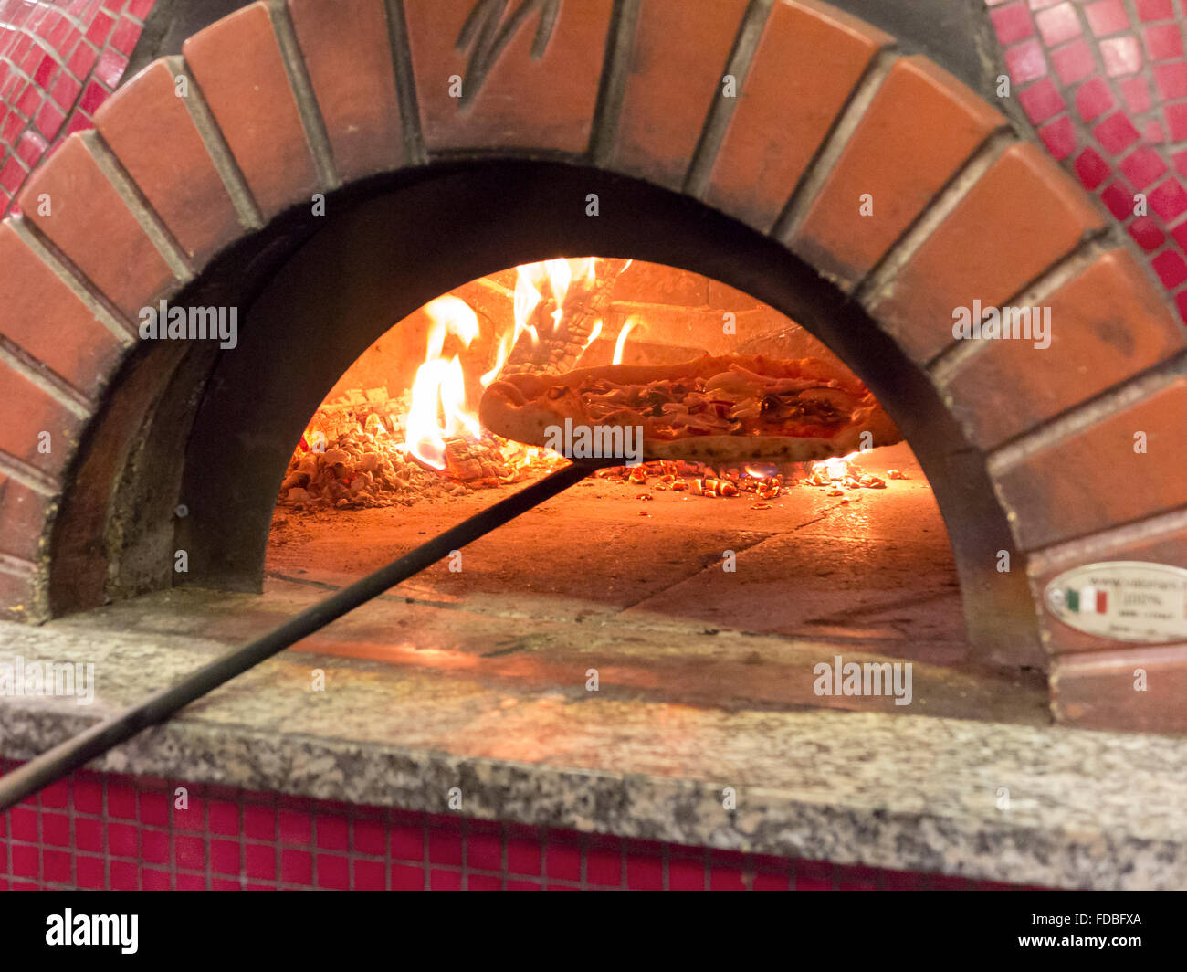 Pizzas baking in an open firewood oven Stock Photo Alamy