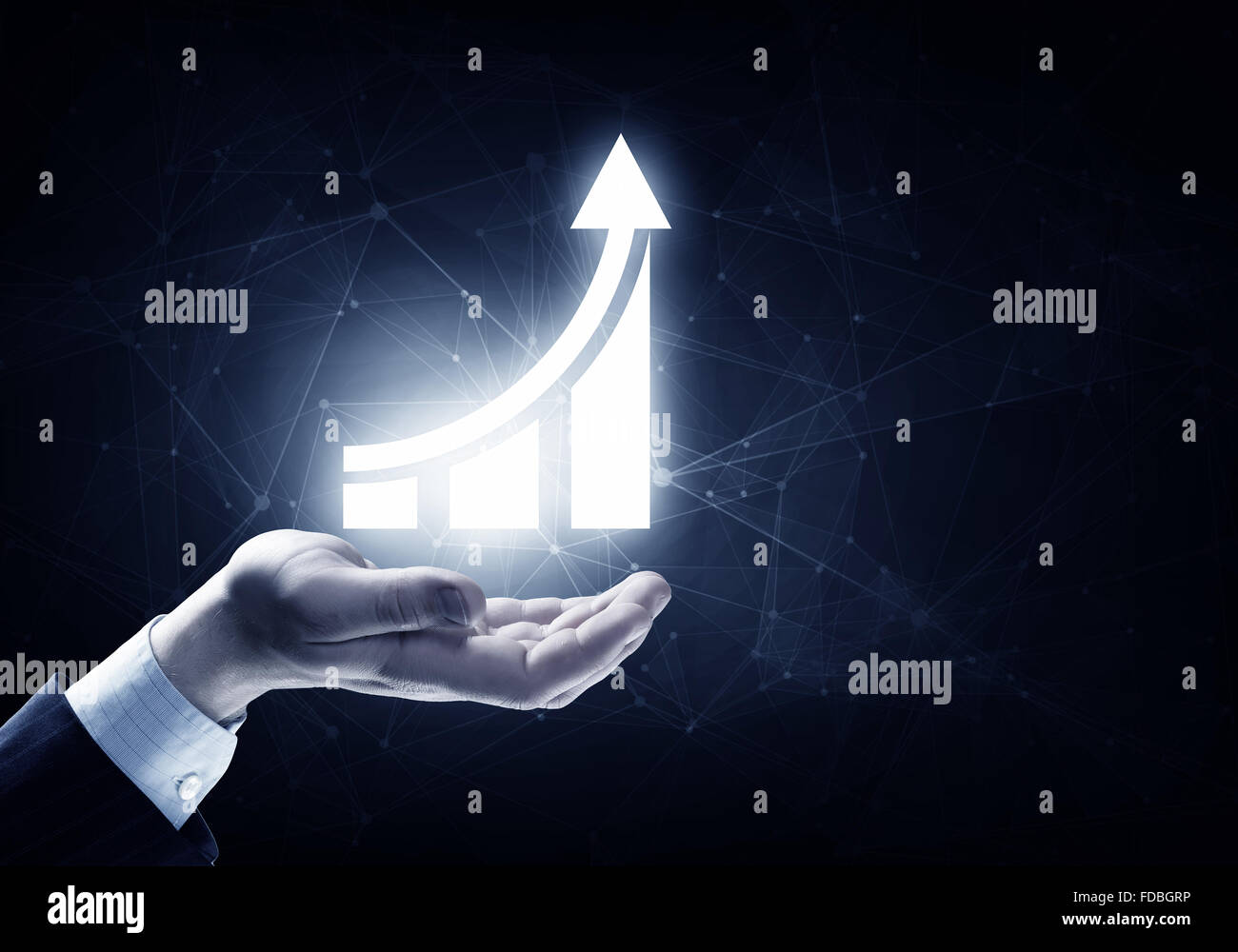 Businessman hand on dark background holding growing graph Stock Photo ...