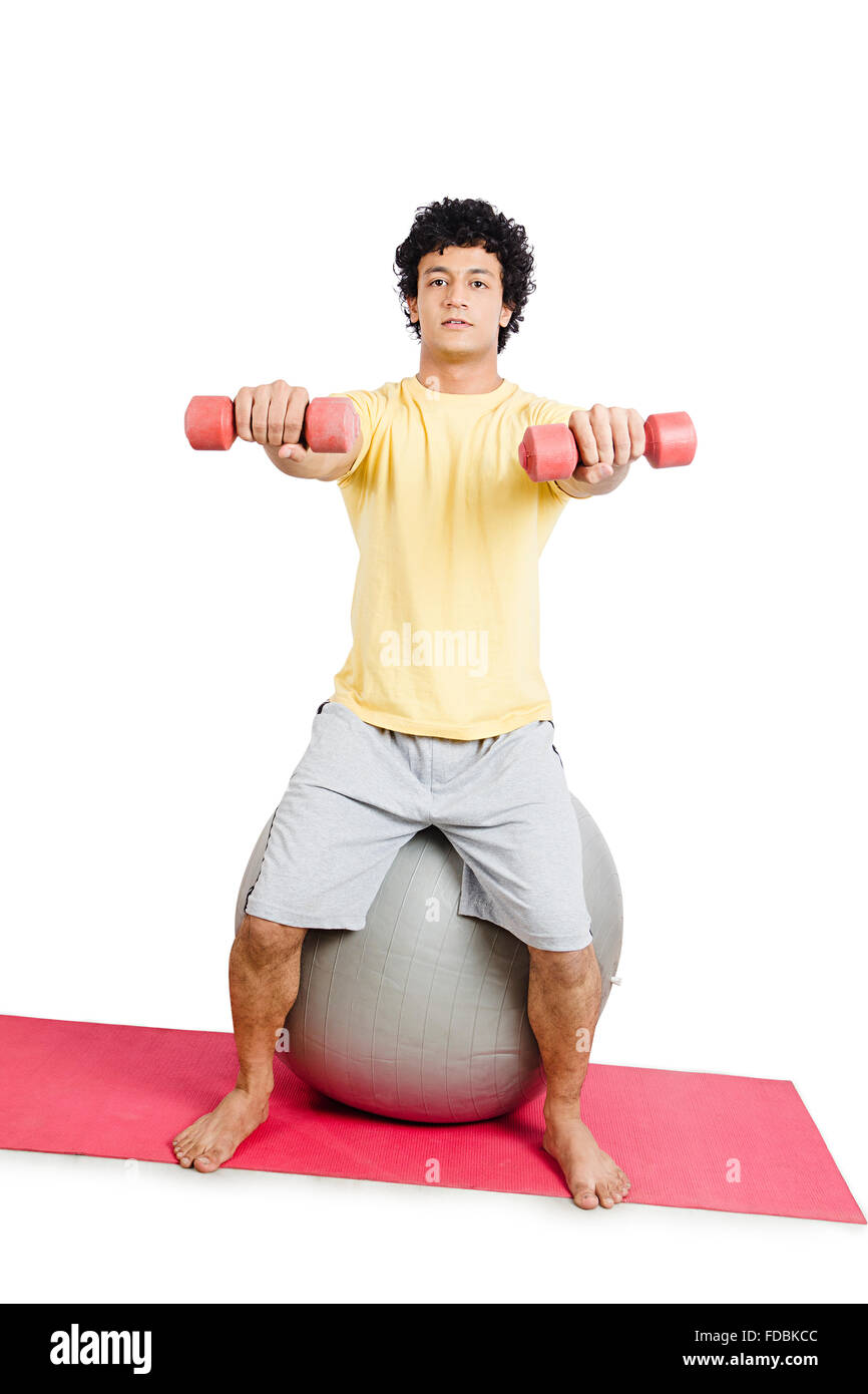 1 Young man Sitting Fitness ball Hand weights Exercising Stock Photo