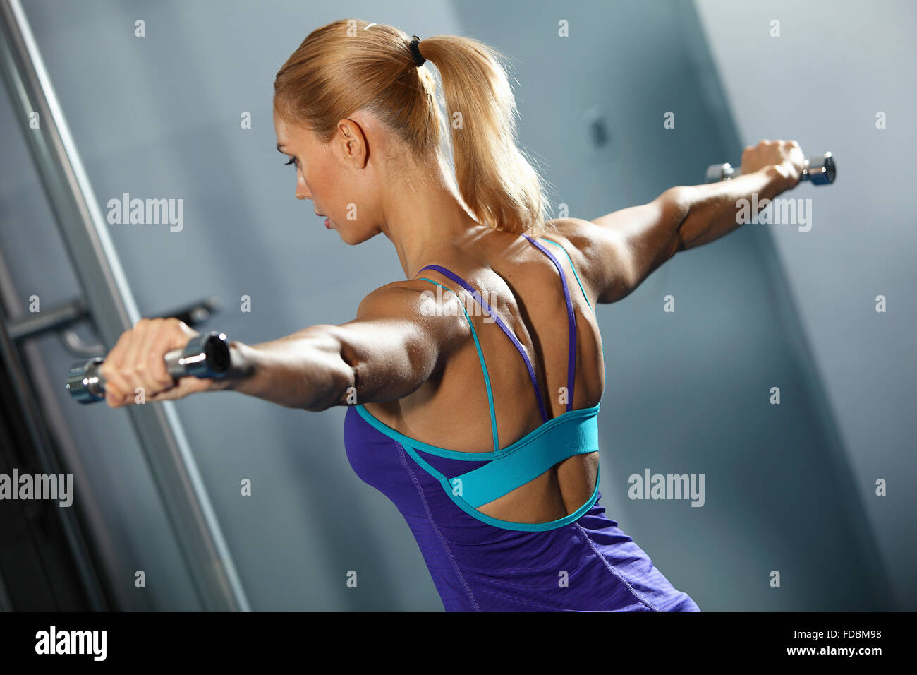 Image of fitness girl in gym exercising with dumbbells Stock Photo