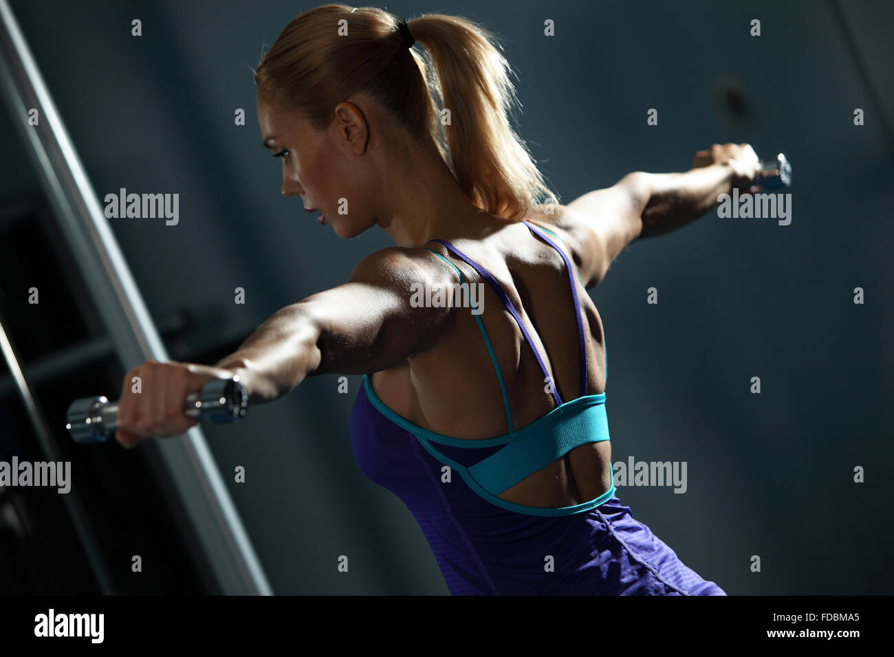 Image of fitness girl in gym exercising with dumbbells Stock Photo