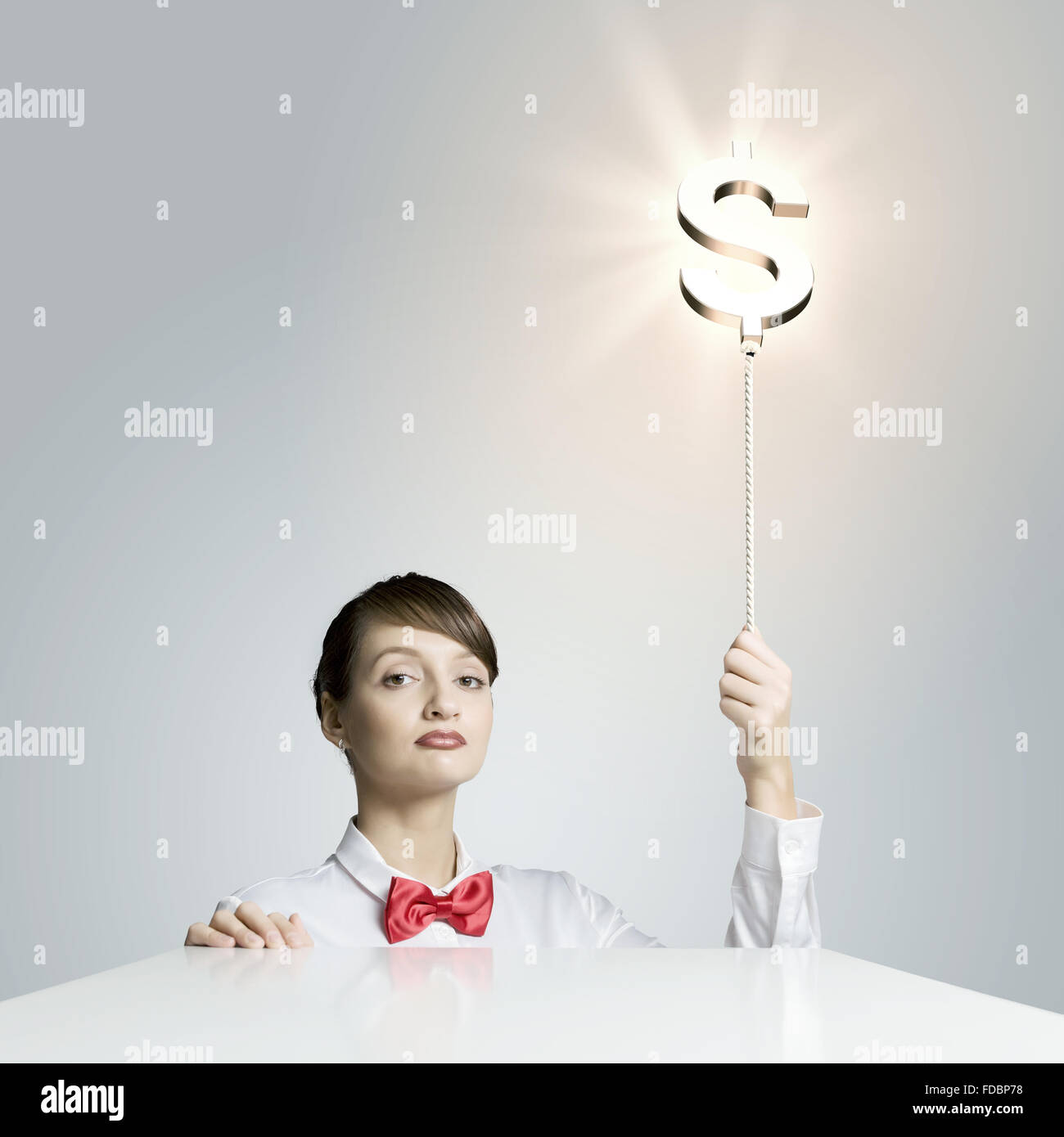 Young woman holding balloon shaped like dollar sign Stock Photo - Alamy