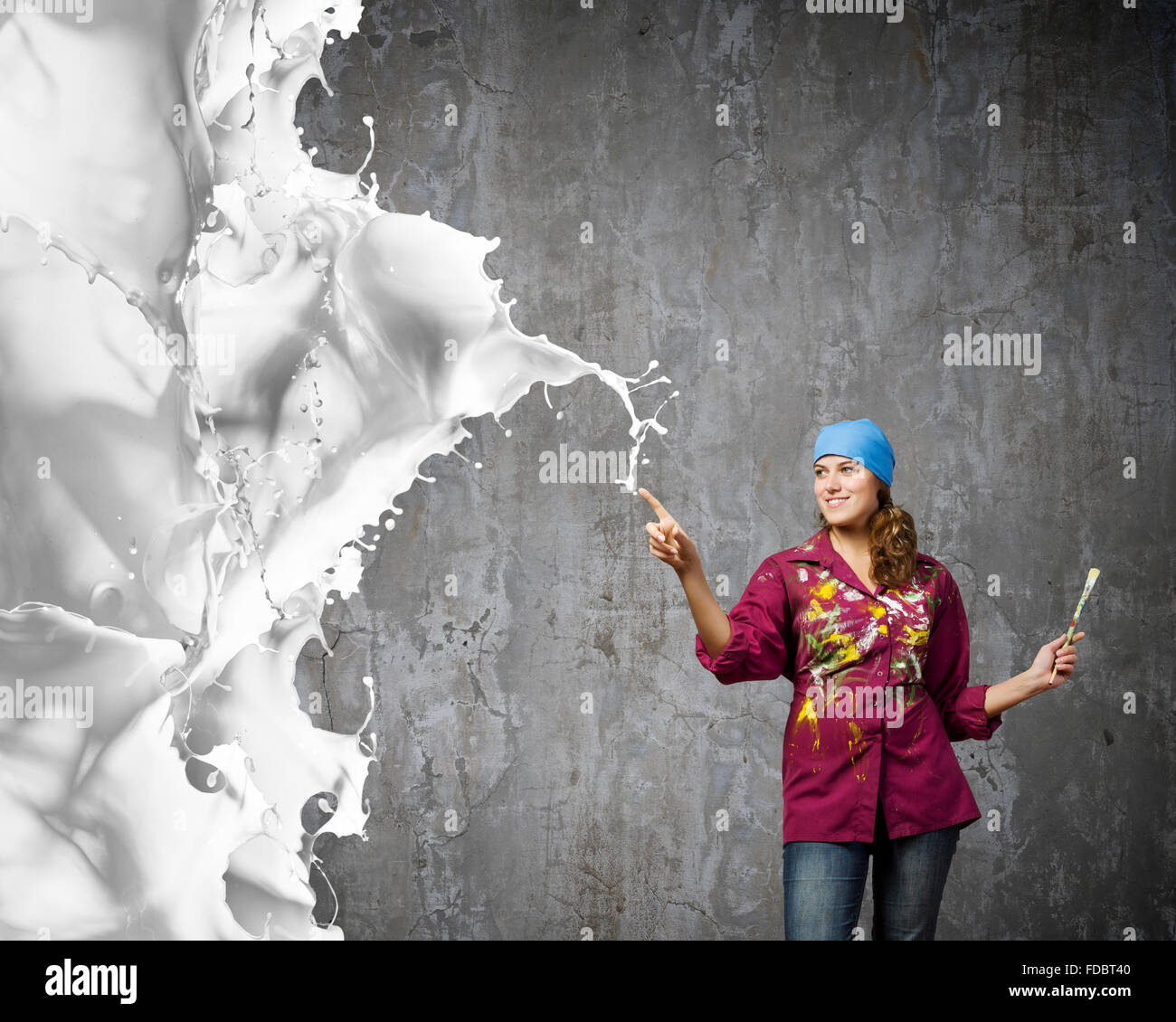 Young woman painter with brush and white splashes above Stock Photo - Alamy