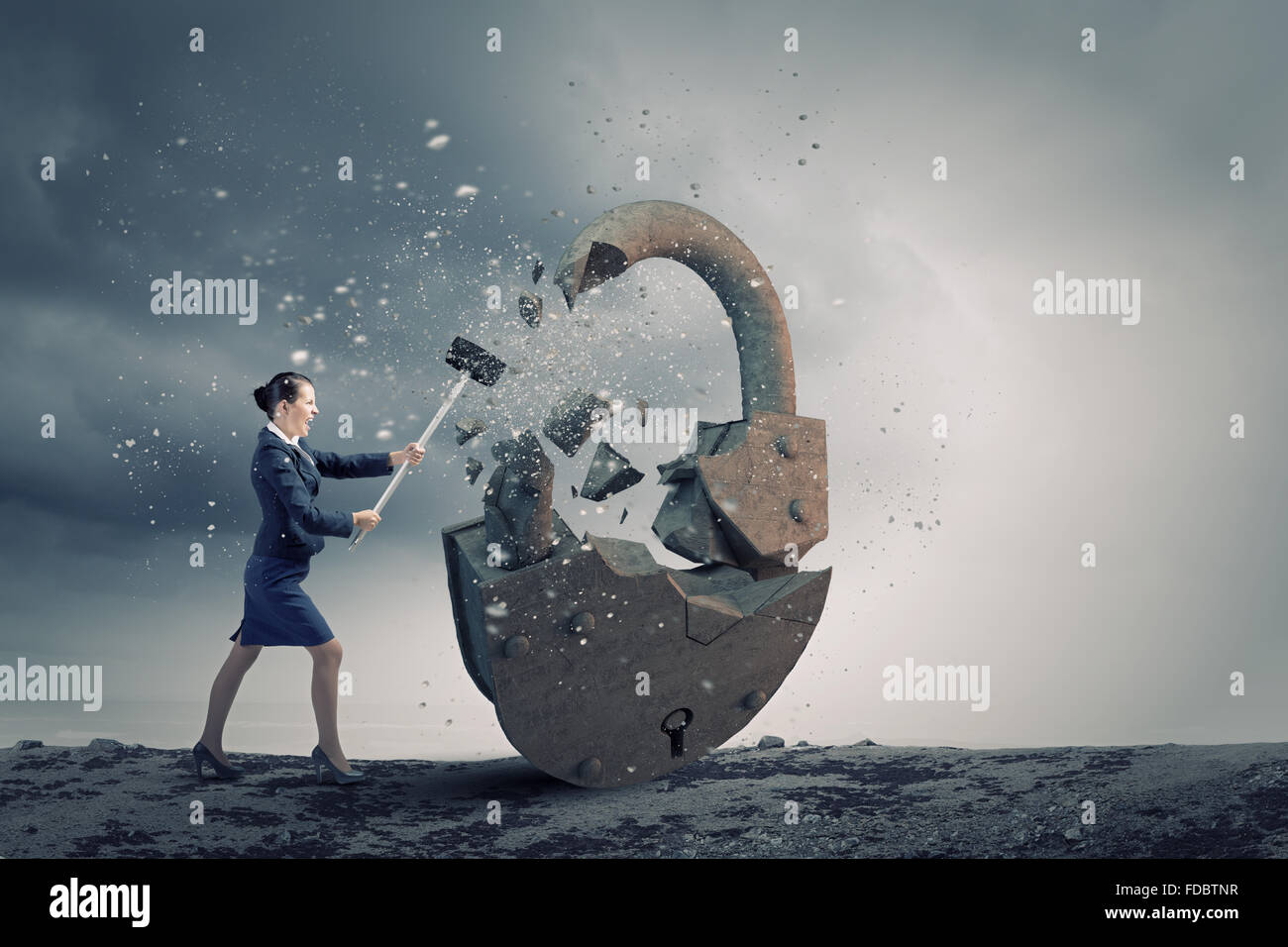 Young angry businesswoman crashing stone lock with hammer Stock Photo ...